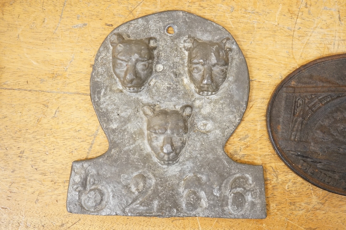 A reproduction Salop cast iron ‘The Iron Bridge 1779’ plaque together with a lead fire-mark, Salop Fire Office, latter 19cm high
